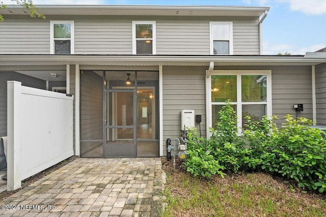 rear view of house featuring a sunroom