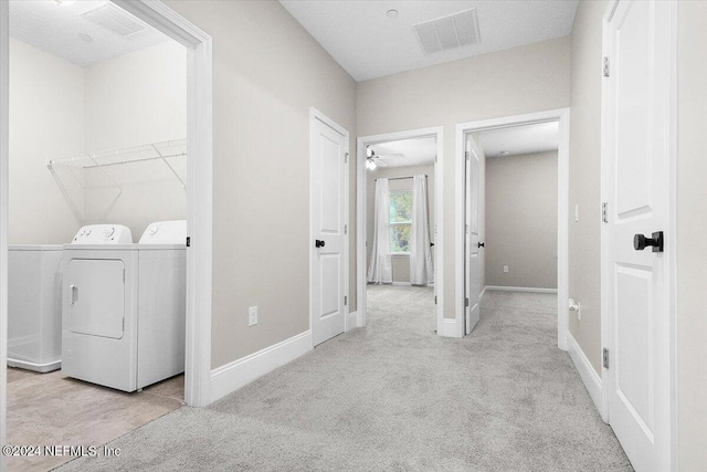 laundry area with laundry area, carpet floors, visible vents, baseboards, and washing machine and clothes dryer