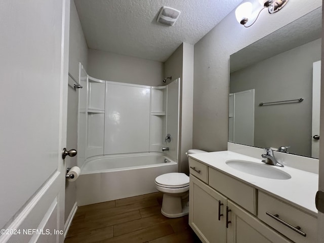 full bathroom with toilet, a textured ceiling, shower / bathtub combination, vanity, and hardwood / wood-style flooring