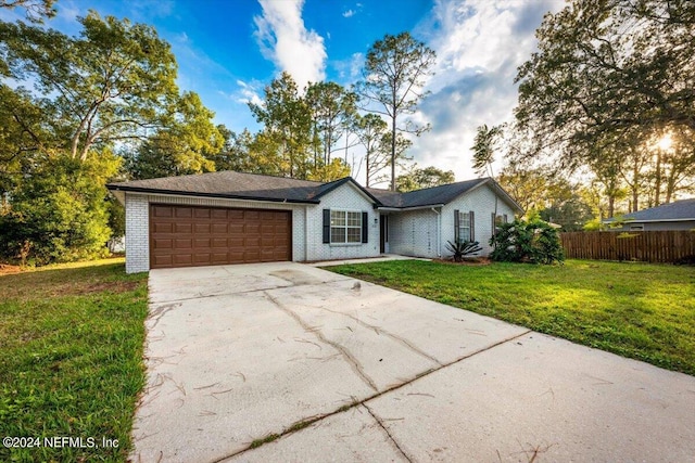 ranch-style house with a garage and a front yard