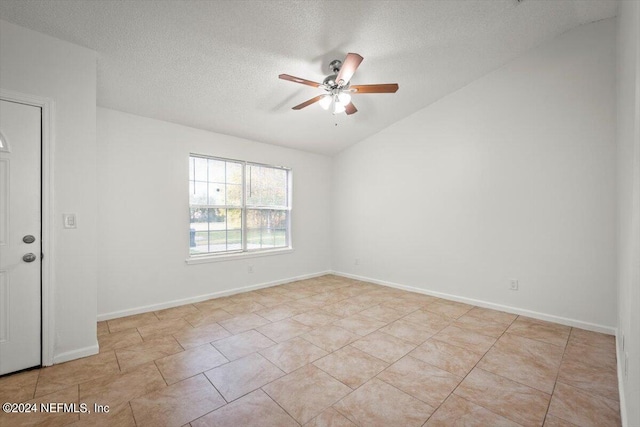 unfurnished room with light tile patterned flooring, a textured ceiling, ceiling fan, and lofted ceiling