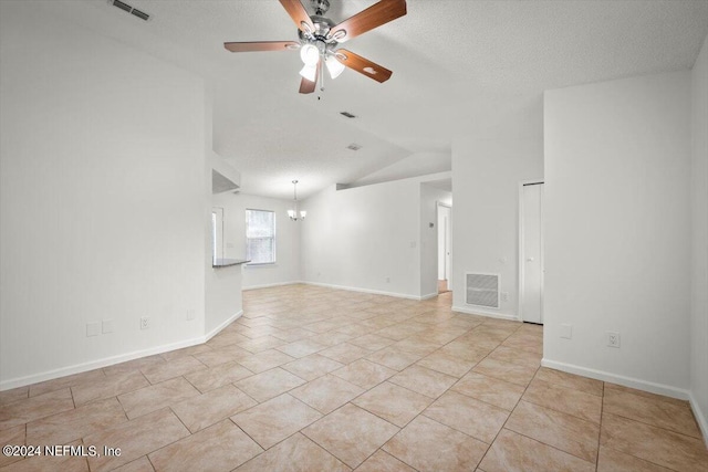 unfurnished room featuring light tile patterned flooring, a textured ceiling, vaulted ceiling, and ceiling fan