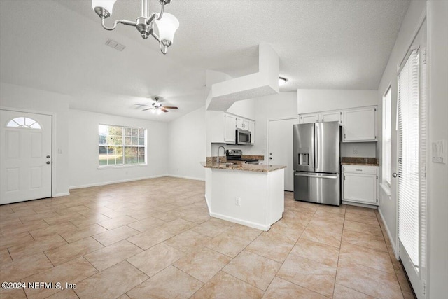 kitchen featuring stainless steel appliances, kitchen peninsula, ceiling fan with notable chandelier, light tile patterned flooring, and white cabinetry