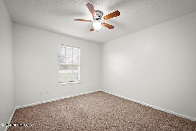 carpeted empty room with a textured ceiling and ceiling fan