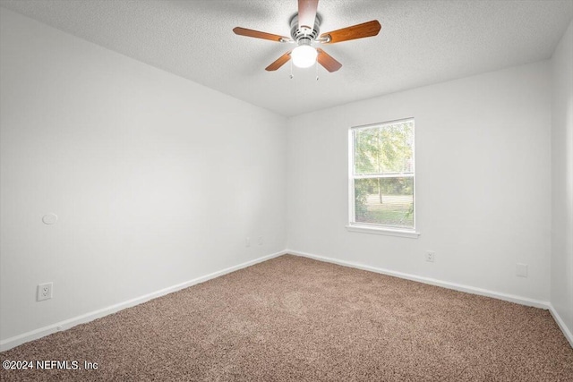 spare room featuring a textured ceiling, carpet, and ceiling fan