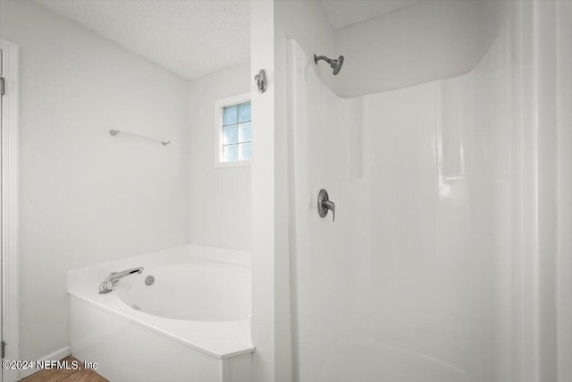 bathroom featuring a bathing tub and a textured ceiling