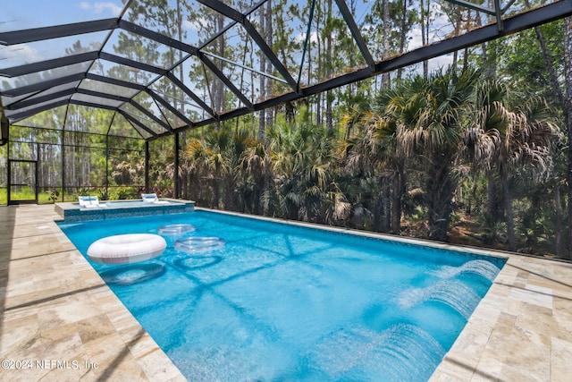 view of swimming pool with a lanai and a patio area