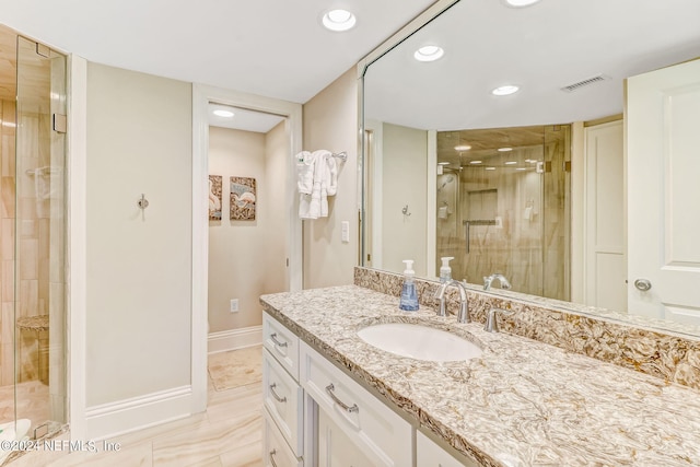 full bathroom with visible vents, baseboards, vanity, a shower stall, and recessed lighting