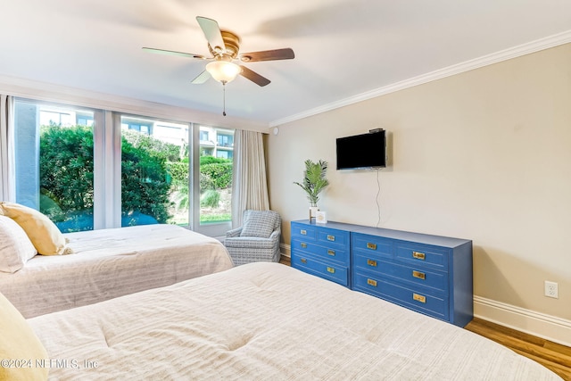 bedroom featuring ornamental molding, wood finished floors, a ceiling fan, and baseboards