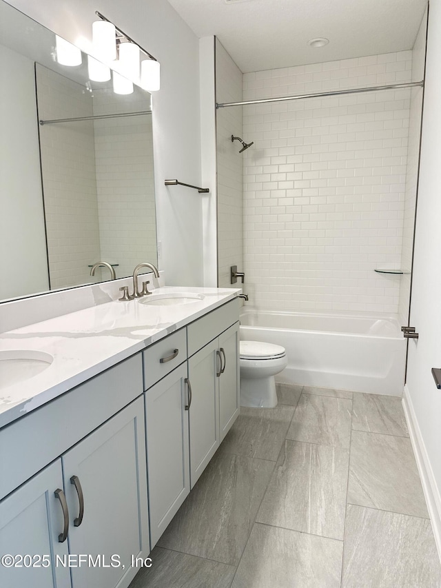 full bath with a sink, shower / tub combination, double vanity, and toilet