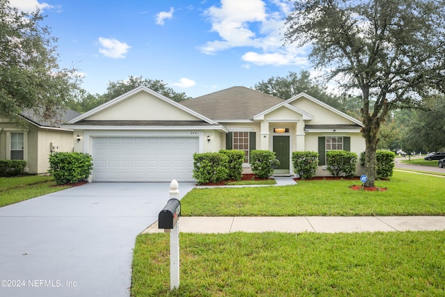 single story home featuring a garage and a front lawn