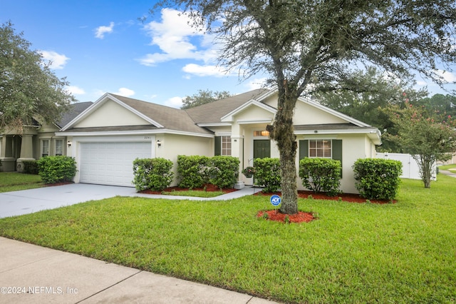 ranch-style house featuring a garage and a front yard