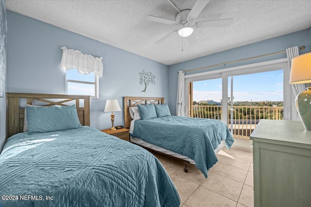 bedroom with multiple windows, light tile patterned floors, access to exterior, and ceiling fan