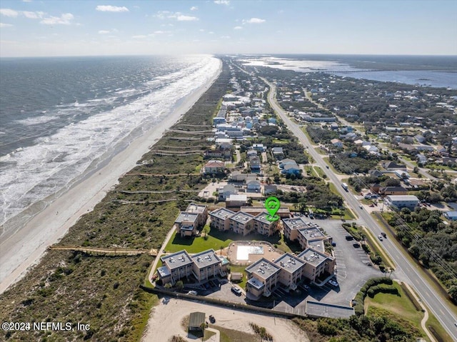 bird's eye view with a water view and a beach view