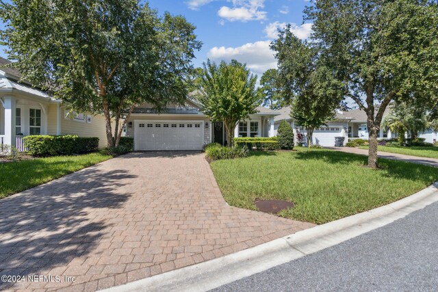 view of front of home with a garage and a front yard