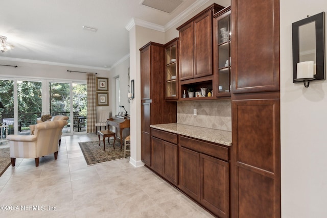 bar featuring ornamental molding, light tile patterned floors, light stone countertops, and backsplash