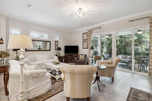 living room with ornamental molding, light tile patterned floors, and plenty of natural light