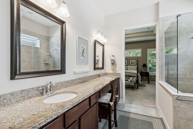 bathroom with double vanity and tile patterned flooring