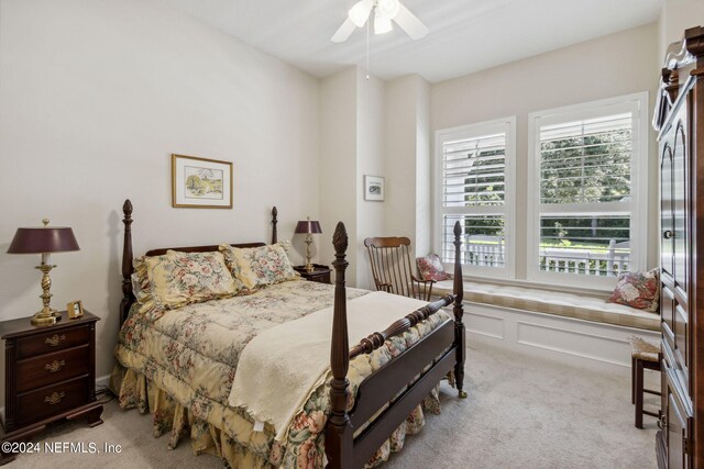 bedroom featuring light colored carpet and ceiling fan