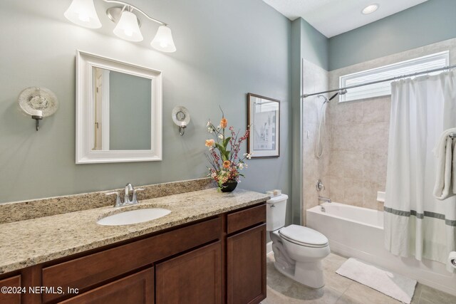 full bathroom featuring tile patterned flooring, shower / bath combo, toilet, and vanity