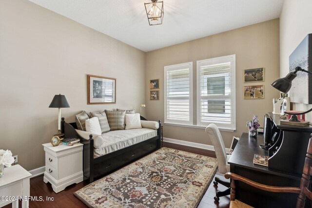 bedroom with dark hardwood / wood-style flooring