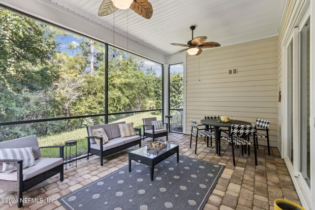 sunroom / solarium featuring ceiling fan