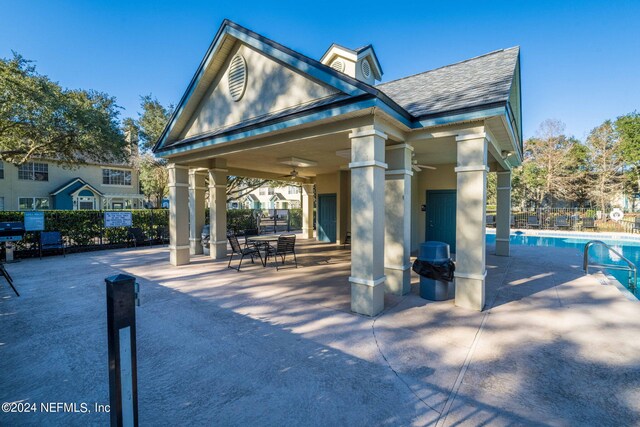 view of property's community featuring a swimming pool, a patio area, and a gazebo