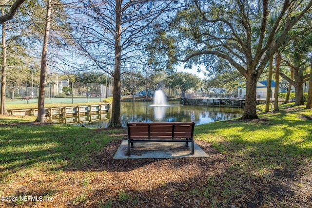 view of property's community featuring a water view and a yard