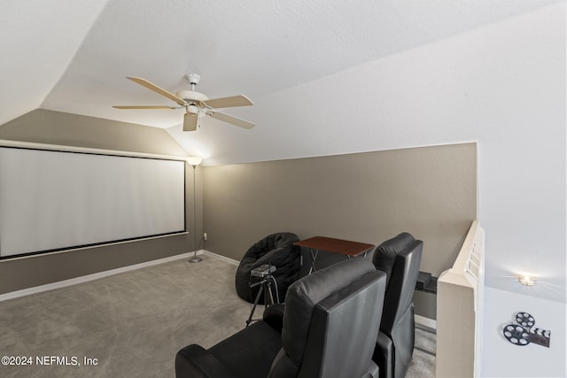 cinema featuring lofted ceiling, light colored carpet, and ceiling fan