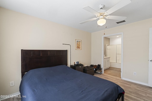 bedroom with ceiling fan, ensuite bath, and light hardwood / wood-style floors