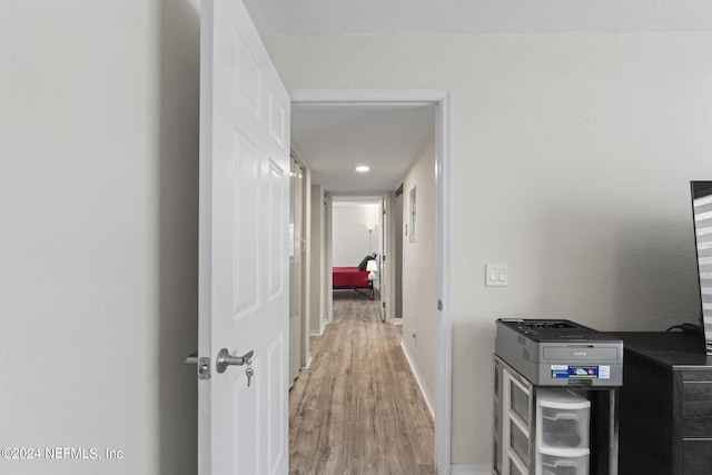 hall with light hardwood / wood-style flooring