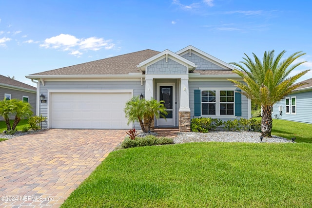 view of front facade with a garage and a front lawn