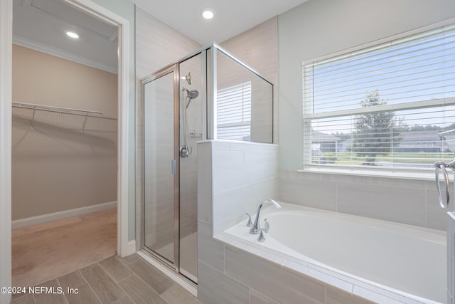 bathroom featuring a stall shower, a garden tub, a spacious closet, and recessed lighting