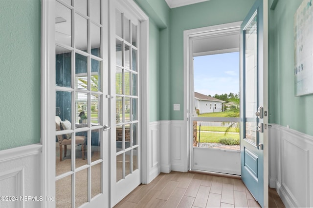 doorway to outside with light wood-type flooring, french doors, and a wealth of natural light