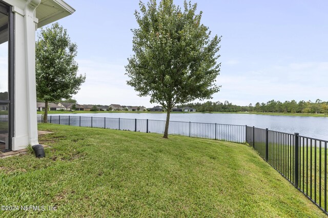 view of yard featuring a water view and a fenced backyard