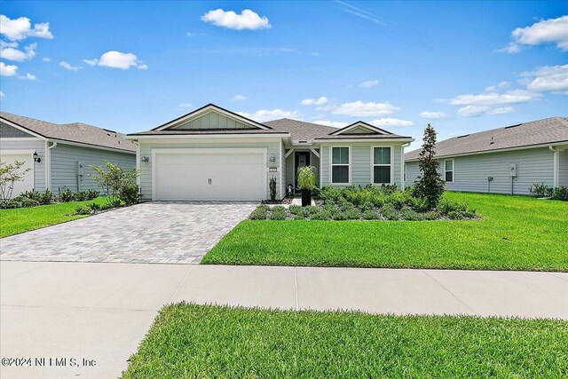 ranch-style home featuring a garage and a front yard