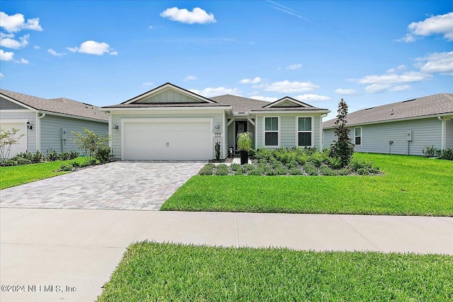 ranch-style house featuring board and batten siding, a garage, decorative driveway, and a front lawn