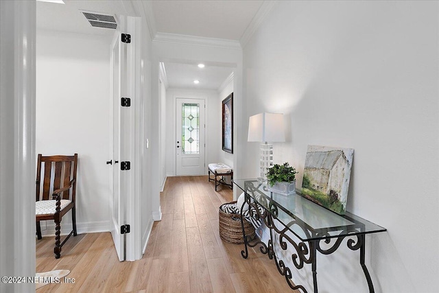 entrance foyer featuring visible vents, crown molding, light wood-style flooring, and baseboards