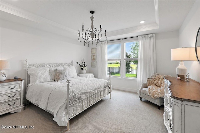 bedroom featuring light carpet, baseboards, a tray ceiling, crown molding, and a chandelier