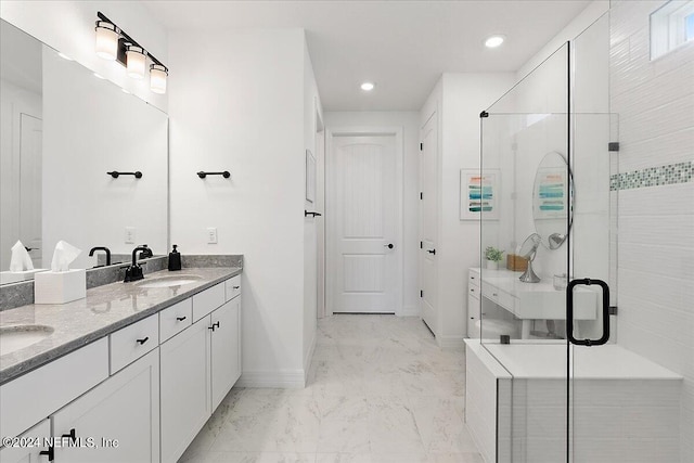 bathroom with a stall shower, baseboards, marble finish floor, and a sink