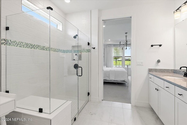 bathroom with baseboards, connected bathroom, vanity, and a shower stall