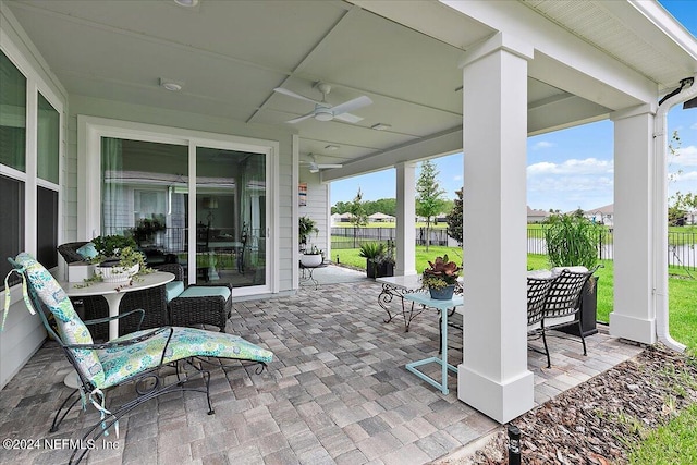 view of patio with ceiling fan, outdoor dining area, and a fenced backyard