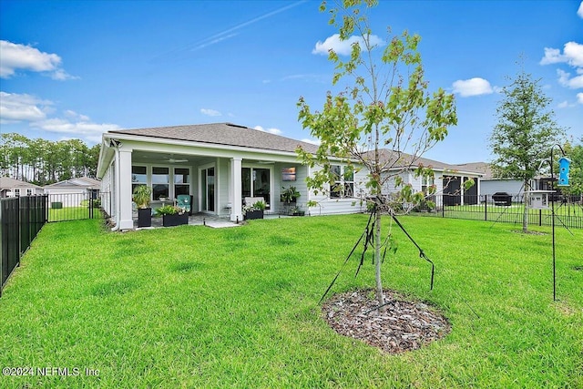 back of property with ceiling fan, a fenced backyard, an outdoor hangout area, a yard, and a patio area