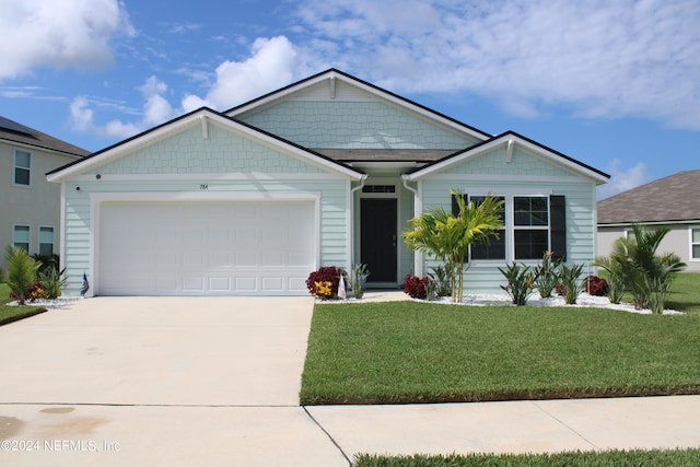 view of front of house featuring a front lawn and a garage