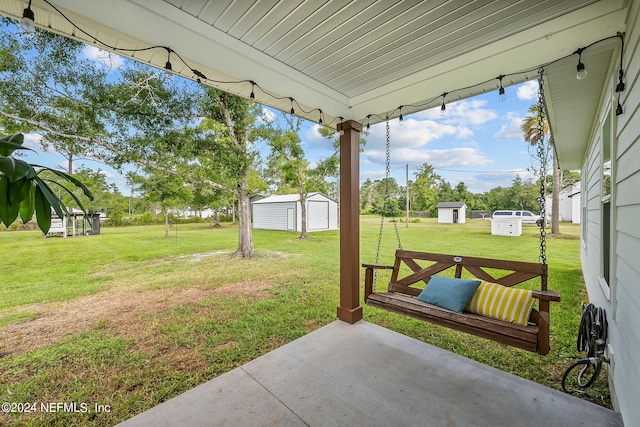 view of yard with a storage shed, a patio area, and an outdoor structure