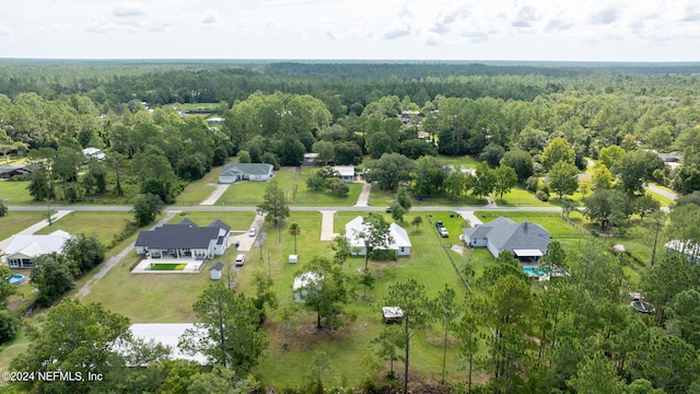 birds eye view of property featuring a wooded view