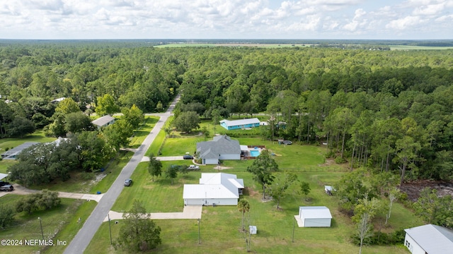 aerial view featuring a wooded view