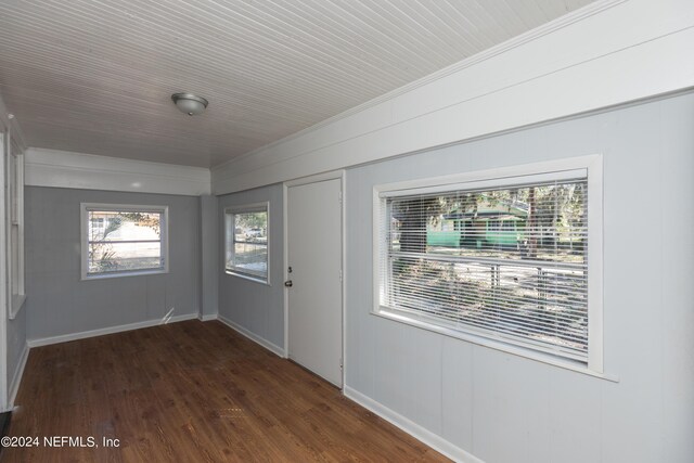 interior space with ornamental molding and dark hardwood / wood-style floors