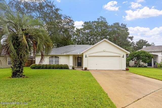 single story home featuring a garage and a front yard