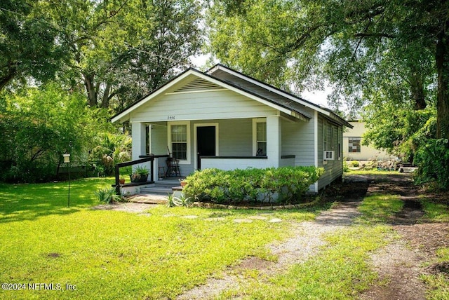 bungalow-style home with driveway, a porch, and a front yard